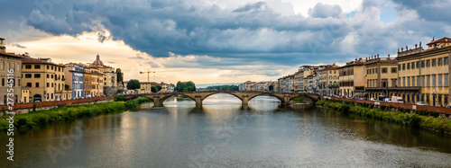 Panoramic view of the Ponte Alla Carraia, a bridge over the Arno River in the Tuscany region of Italy, as it passes through the city of Florence. 