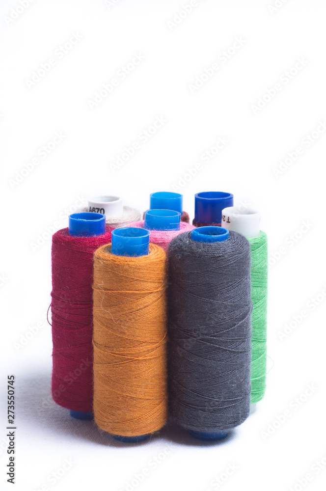 Spools of thread standing vertically on white background Spools of thread standing vertically on white background