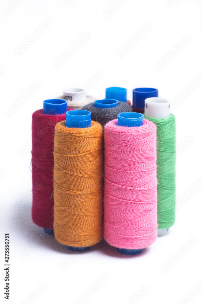 Spools of thread standing vertically on white background Spools of thread standing vertically on white background