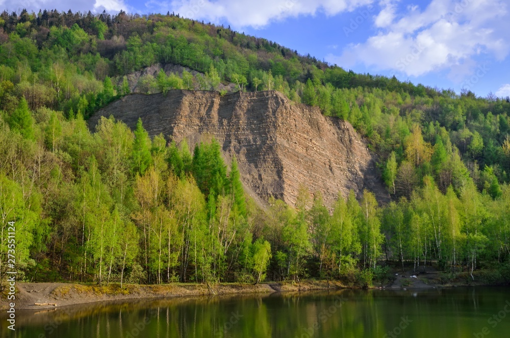 Beautiful spring mountain landscape. Quarry in the mountains by the lake.