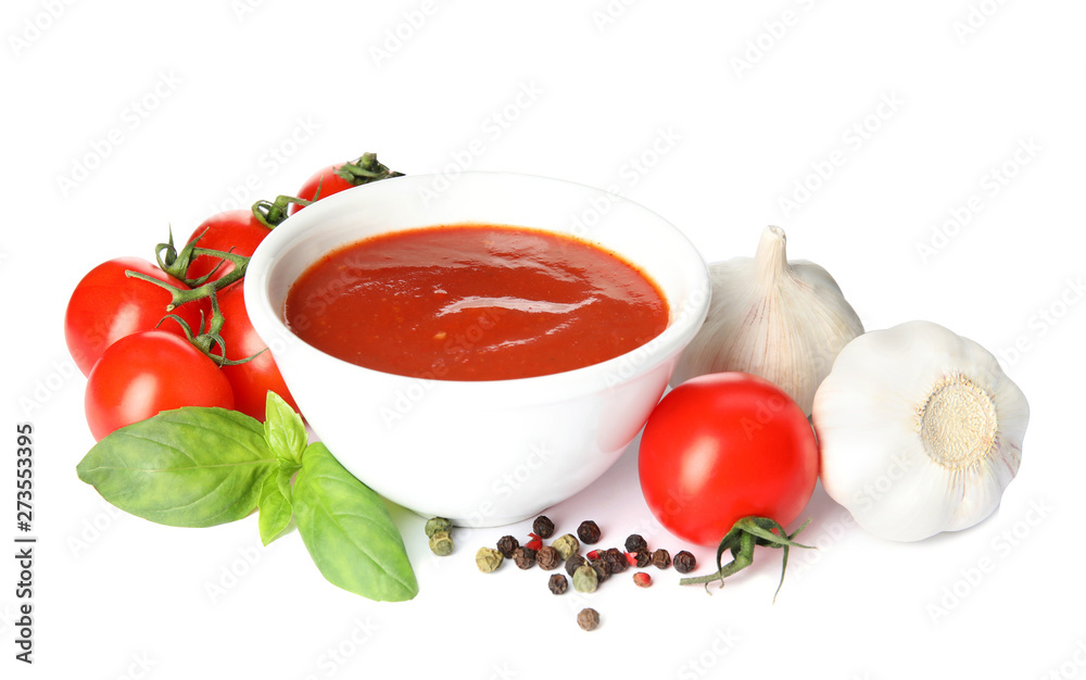 Composition with bowl of tomato sauce and vegetables isolated on white Composition with bowl of tomato sauce and vegetables isolated on white