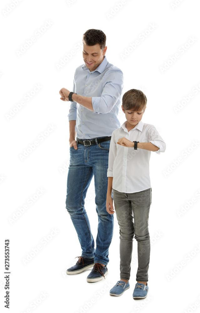 Portrait of dad and his son checking time isolated on white Portrait of dad and his son checking time isolated on white