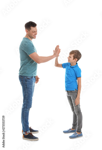 Portrait of dad and his son giving high five isolated on white