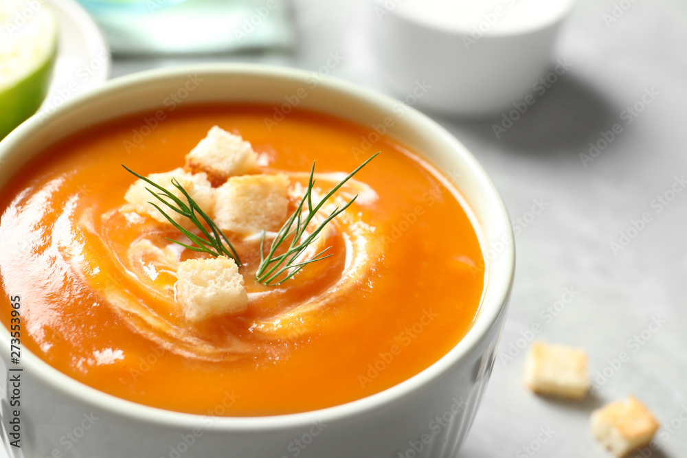 Bowl of tasty sweet potato soup on table, closeup Bowl of tasty sweet potato soup on table, closeup