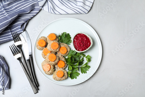 Flat lay composition with plate of traditional Passover (Pesach) gefilte fish on light background. Space for text