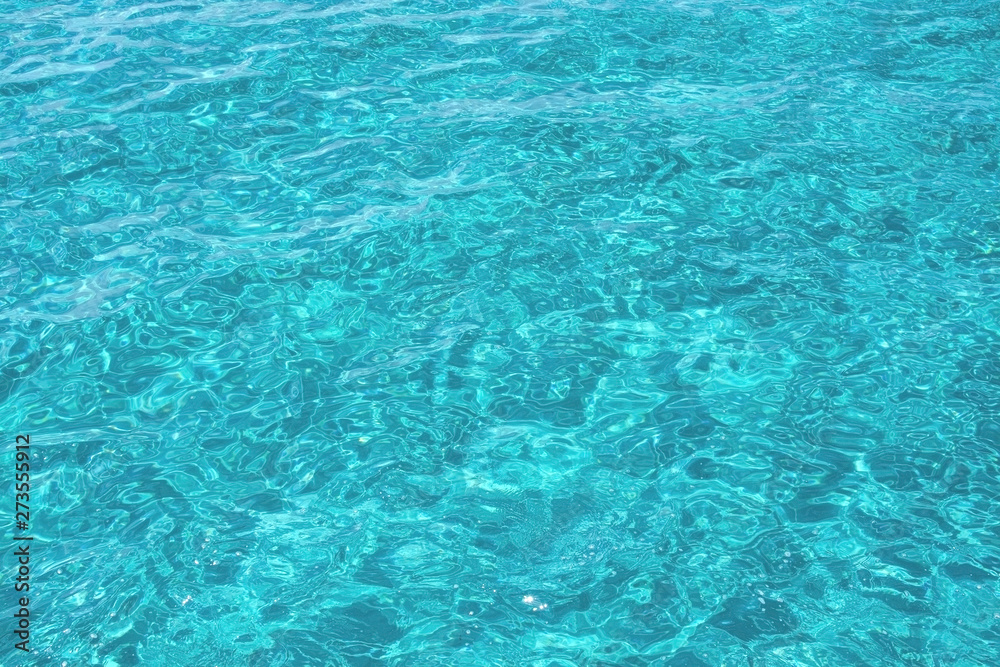 Turquoise sea water full frame closeup background texture