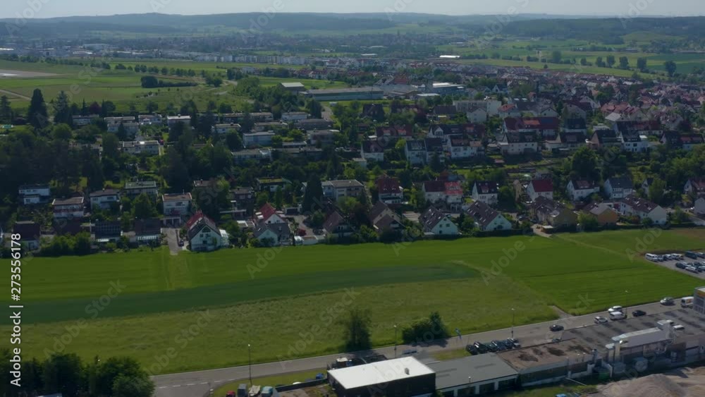 Aerial of Malmsheim, Germany in the foothills of the Black Forest. Camera pans right along a green field toward town, then rotates right with wide view of town. Aerial of Malmsheim, Germany in the foothills of the Black Forest. Camera pans right along a green field toward town, then rotates right with wide view of town.
