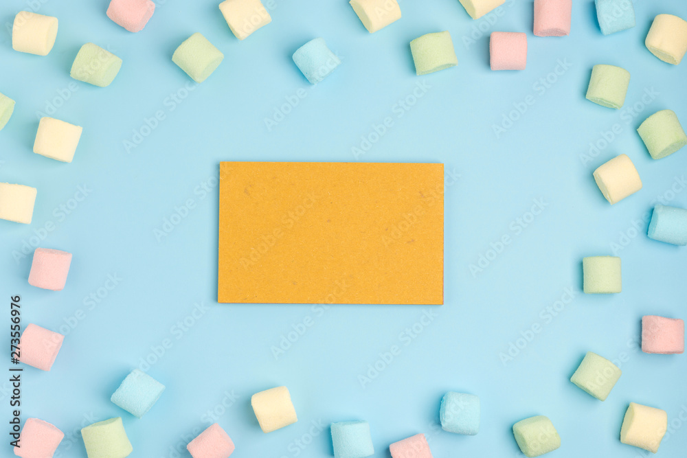 Blue paper background with marshmallow and notepad. Place for your text. Cozy sweet background Blue paper background with marshmallow and notepad. Place for your text. Cozy sweet background