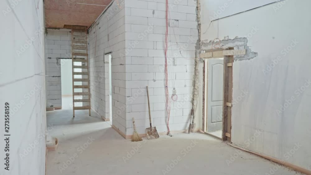 Under construction empty office space. The movement of the camera in the room, inspection of the interior. Empty large apartment with white walls in the new building in the process of repair. Plastic Under construction empty office space. The movement of the camera in the room, inspection of the interior. Empty large apartment with white walls in the new building in the process of repair. Plastic