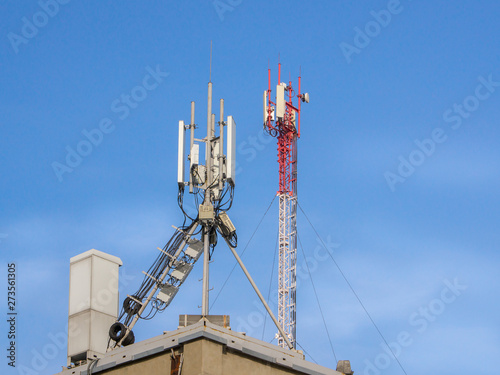 Telecommunication base stations network repeaters on the roof of the building photo