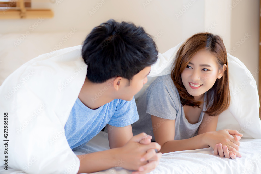 Beautiful portrait young asian couple relax and satisfied together in bedroom at home, family lying on bed confident with cheerful and happy with relationship, man and woman dating. Beautiful portrait young asian couple relax and satisfied together in bedroom at home, family lying on bed confident with cheerful and happy with relationship, man and woman dating.