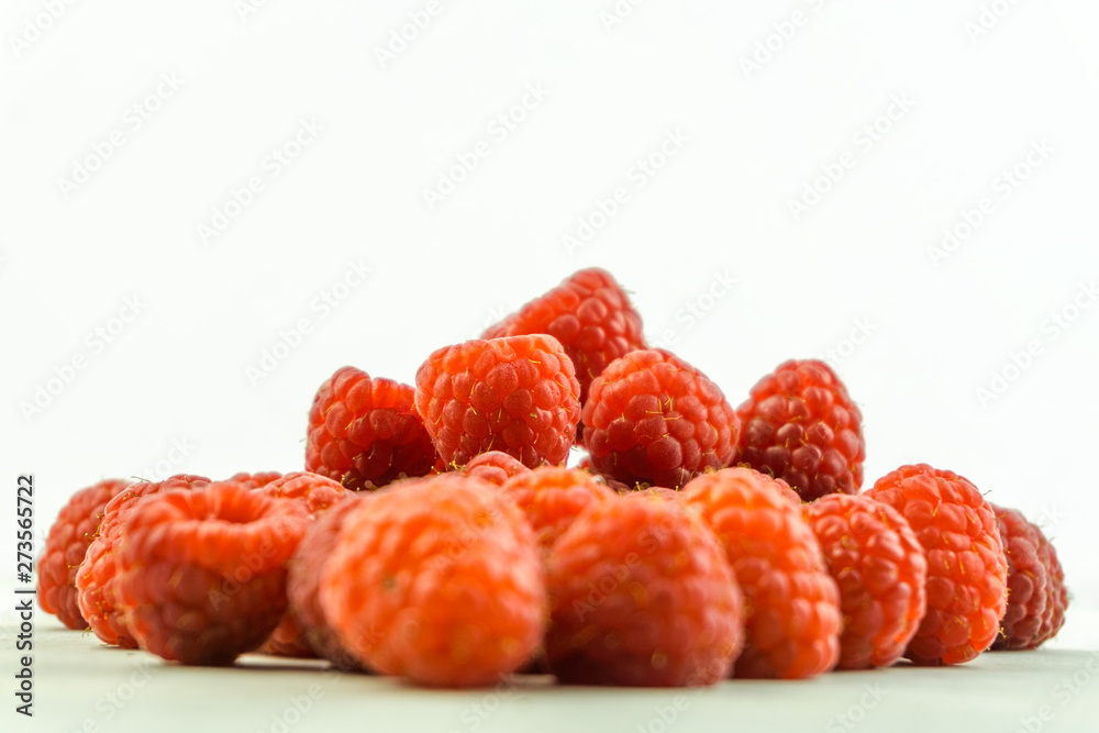 Pile of fresh red ripe Raspberries on wooden table Pile of fresh red ripe Raspberries on wooden table