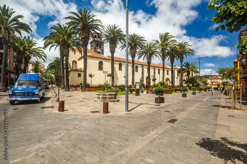 A vintage car passes by Square with fountain near the church of the Immaculate Conception in La Laguna town on Tenerife island