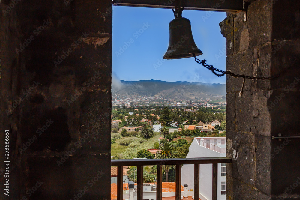 View through the window of church tower of the historic town of San Cristobal de La Laguna in Tenerife showing the buildings and streets with mountains in the background