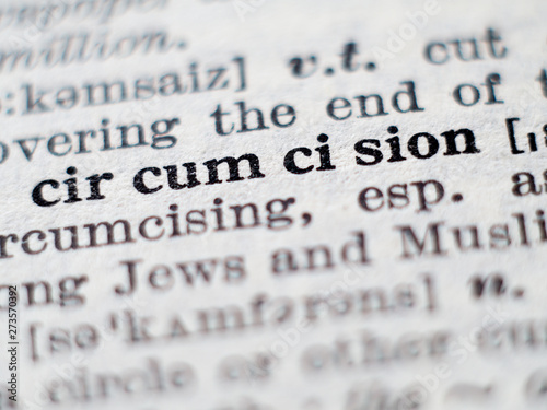 Dictionary definition of word circumcision. Selective focus. photo