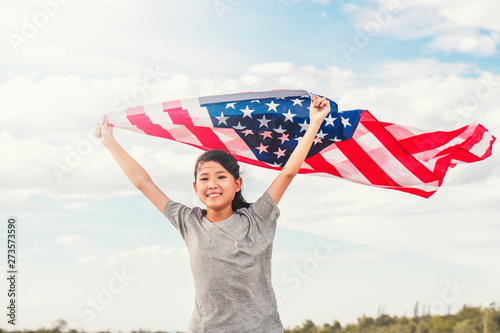 Happy asian little girl with American flag USA celebrate 4th of July