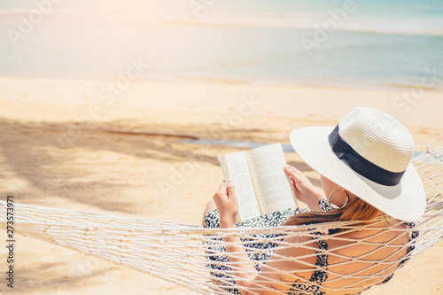 Woman reading a book on hammock beach in free time summer holiday #273573971