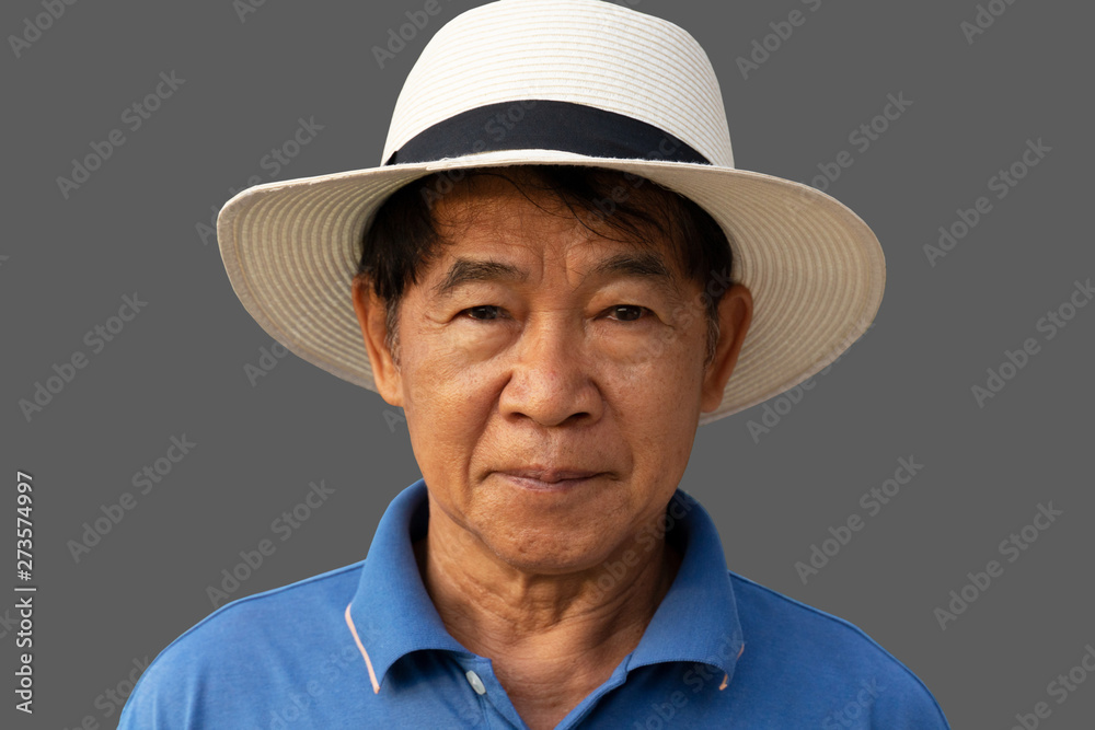 60s Asia man portrait with white hat for travel on grey background 60s Asia man portrait with white hat for travel on grey background