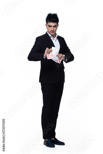 Full Length Snap Figure, Caucasian Business Man Stand in dark Black proper Suit pants and shoes, studio lighting white background isolated, Western Male Model happy smile with magician cards