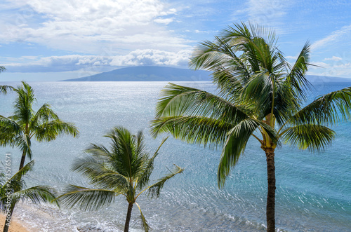 Tropical Island - A bright sunny day at north-west coast of Maui island, with Lanai island at horizon. Maui, Hawaii, USA.