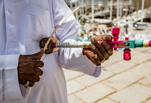 Jordanian Vendor Demonstrates How to Play Native Three String Instrument.