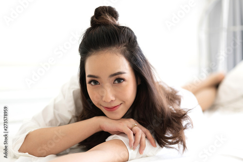 Portrait of asia woman enjoy and relax on the bed in bedroom at home.asian beauty