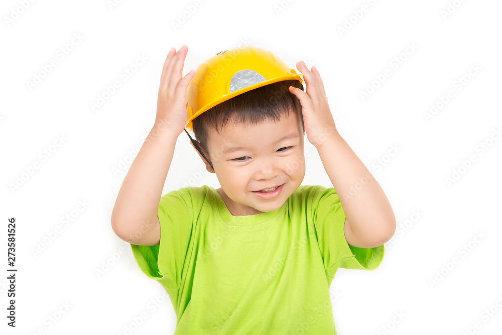 Little Asian toddler boy playing wood blocks wear helmet engineer