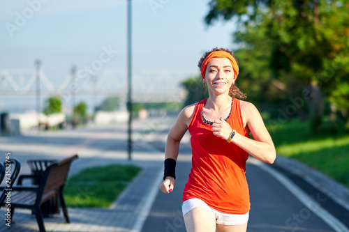 Running Woman on racetrack during training session. Female runner practicing on athletics race track