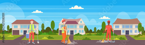 street cleaners team in uniform working together mix race male workers sweeping garbage cleaning service concept modern cottage house countryside background full length flat horizontal