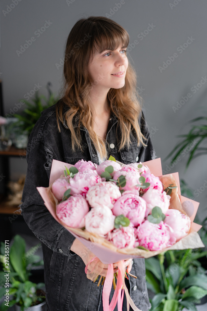 Pink peonies in womans hands. Beautiful peony flower for catalog or online store. Floral shop concept . Beautiful fresh cut bouquet. Flowers delivery Pink peonies in womans hands. Beautiful peony flower for catalog or online store. Floral shop concept . Beautiful fresh cut bouquet. Flowers delivery
