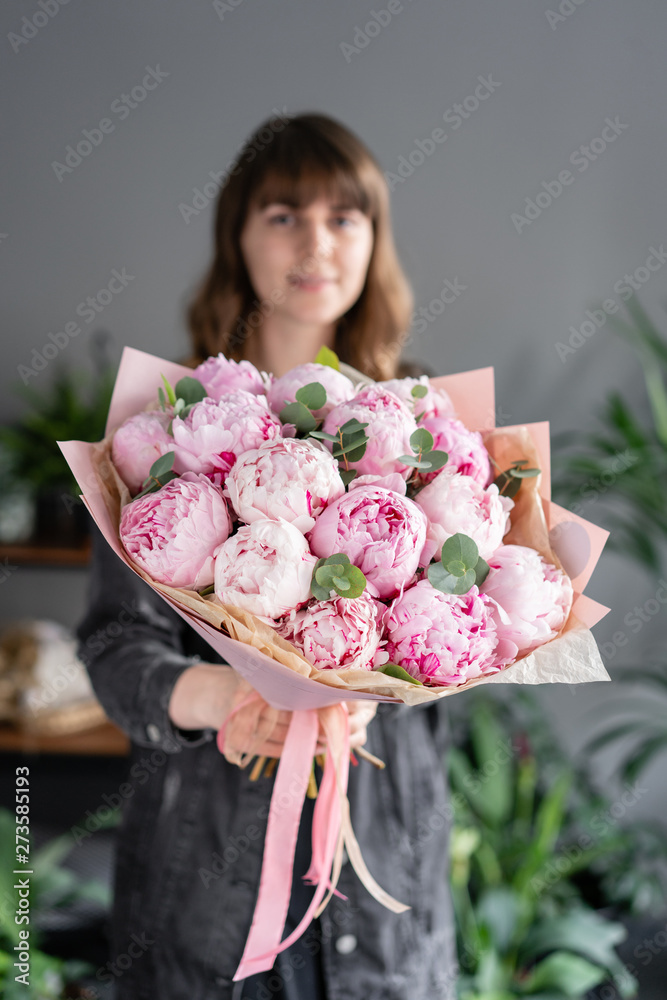 Pink peonies in womans hands. Beautiful peony flower for catalog or online store. Floral shop concept. Flowers delivery Pink peonies in womans hands. Beautiful peony flower for catalog or online store. Floral shop concept. Flowers delivery