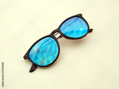 Children sunglasses, sun shades or spectacles isolated on yellow background. Color child glasses protection from sun and UV rays. Concept of sun protection and vacation.