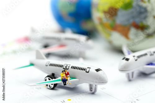 Miniature people : sitting with airplane,for travel around the world concept. © keatikun