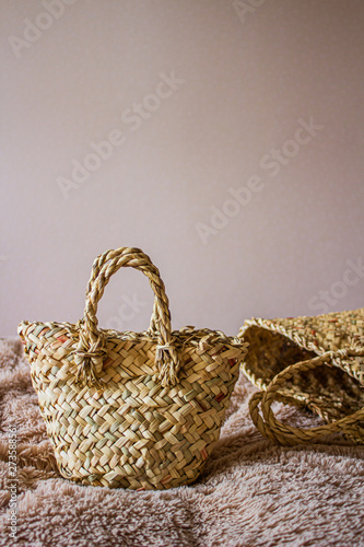 Beautiful female straw hand bag on natural background.