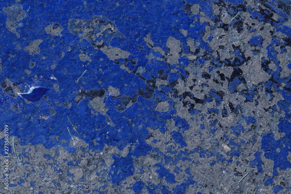 Toned asphalt surface with paint on it close up. Abstract background