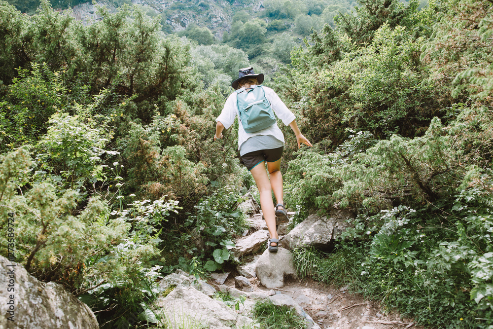 Naklejka premium Young lady tourist hiking in the mountains of Georgia