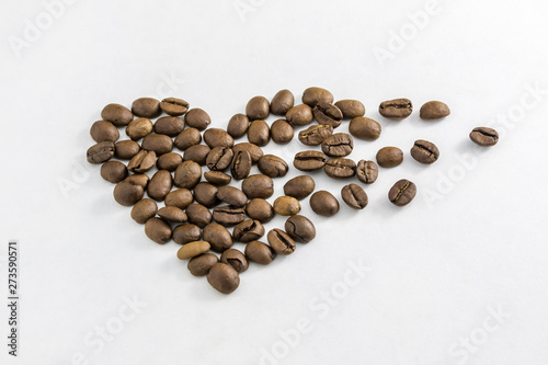 Coffee beans in the shape of a heart on a white background. Concept of freshness or great aroma and energy. Concept of Valentine's day.