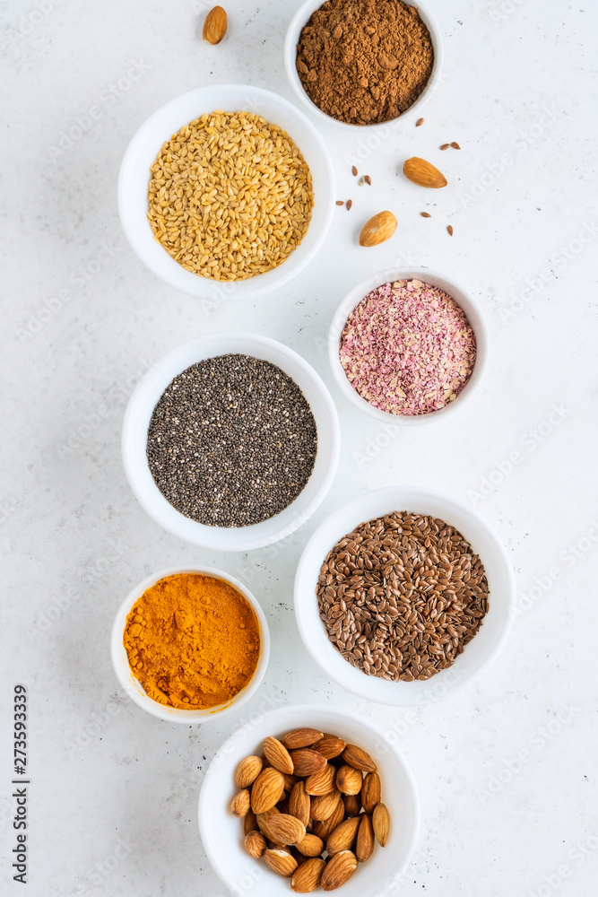 Healthy super food clean eating selection (seeds, powder turmeric, carob, nuts, dried beet) Healthy super food clean eating selection (seeds, powder turmeric, carob, nuts, dried beet)