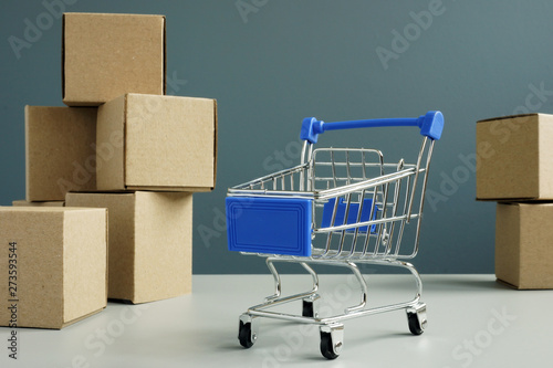 Shopping card and cardboard boxes. Online shopping and delivery concept.