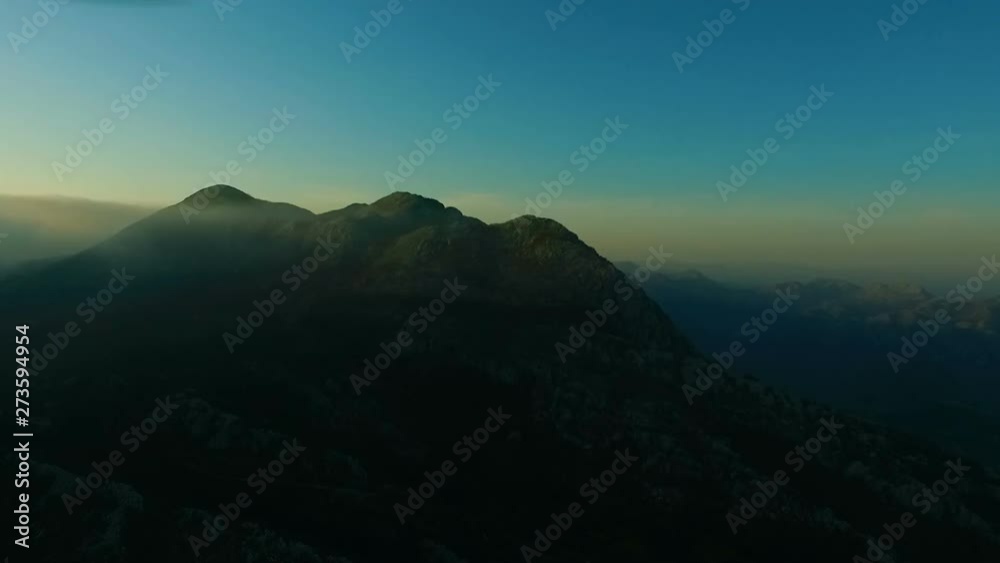 Aerial view of a fog covered Mountain Landscape during a colorful gloomy sunset Aerial view of a fog covered Mountain Landscape during a colorful gloomy sunset