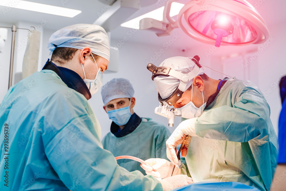 Team surgeon at work in operating room. Modern equipment in operating room. Medical devices for neurosurgery. Team surgeon at work in operating room. Modern equipment in operating room. Medical devices for neurosurgery.
