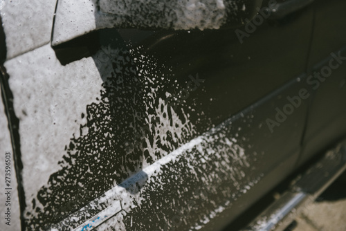 Car in the foam. Car wash. Car in the foam from cleaning agent