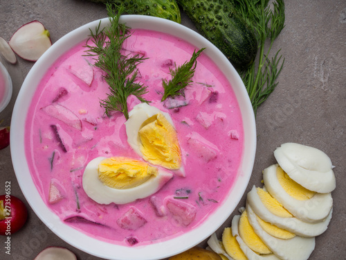 Cold beetroot soup. Holodnik.Traditional Lithuanian ukrainian, russian, polish red beet soup. Cold borscht with cucumbers, dill and eggs photo