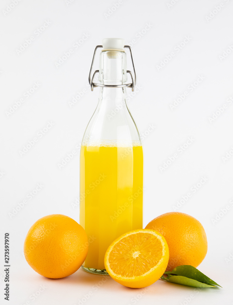 Fresh healthy orange juice in a glass bottle on white background. summer concept. Fresh healthy orange juice in a glass bottle on white background. summer concept.