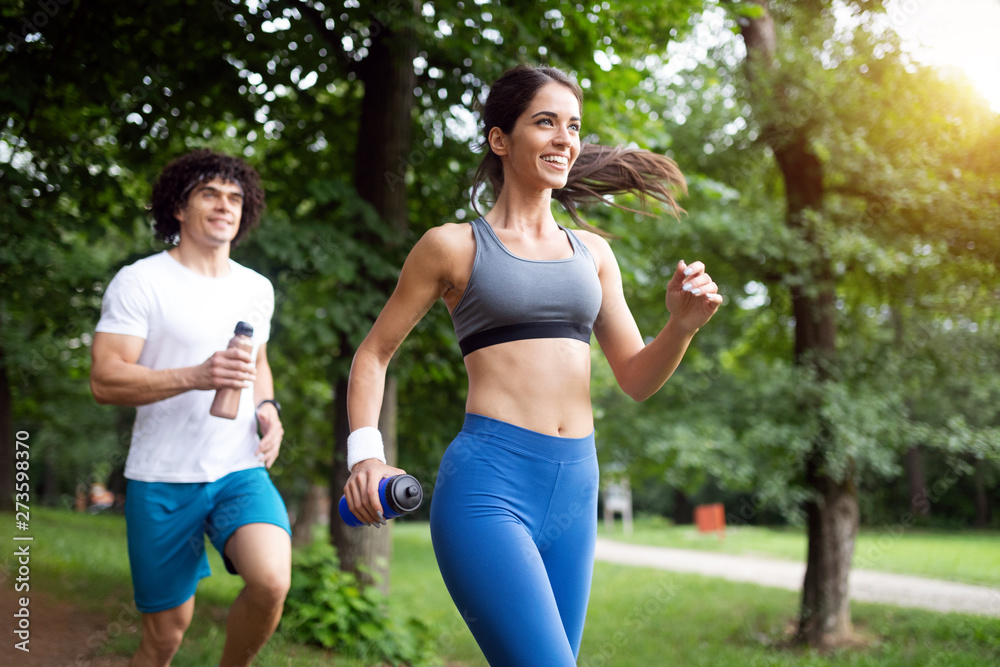 Fototapeta premium Happy couple running and jogging together outdoor
