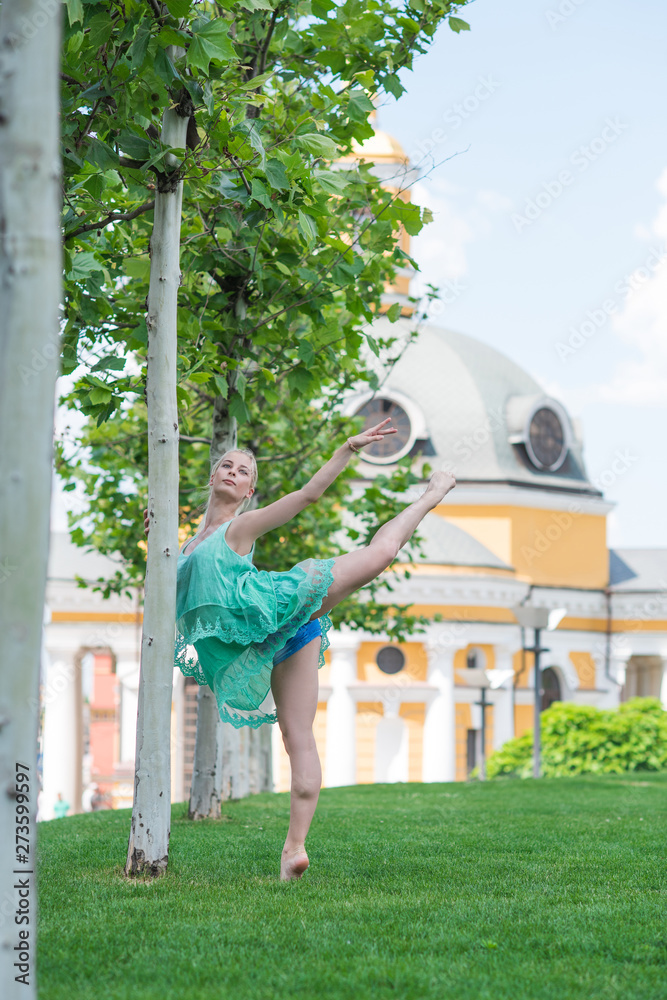 Ballerina in city. Ballet dancer dancing outdoor. Concept of freedom and sport body 