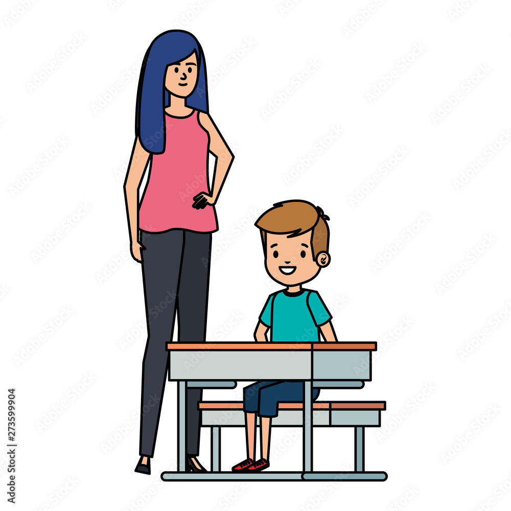 student boy seated in school desk with female teacher