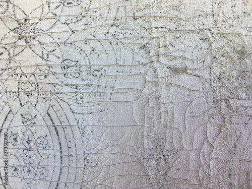 wall with cracked pattern on white wallpaper