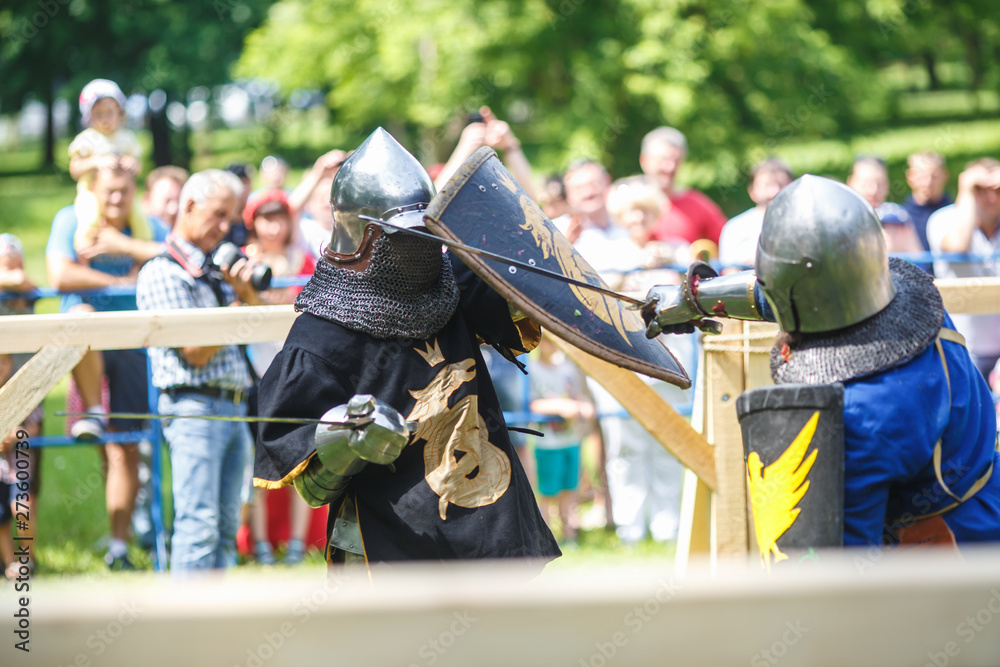 medieval jousting knight fight, in armor, helmets, chain mail with axes and swords on lists. historic reconstruction of ancient fight medieval jousting knight fight, in armor, helmets, chain mail with axes and swords on lists. historic reconstruction of ancient fight