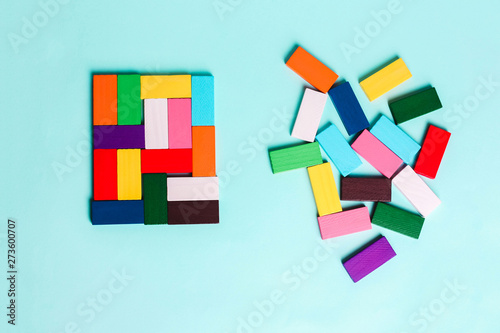 order and chaos. Chaotic unorganized colored dominoes and ordered. Concept of business model, organization. L photo